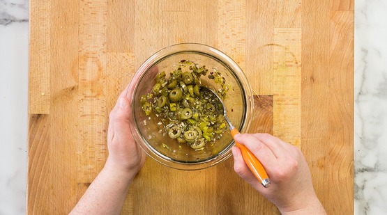 Mix the puttanesca dressing Mix the puttanesca dressing