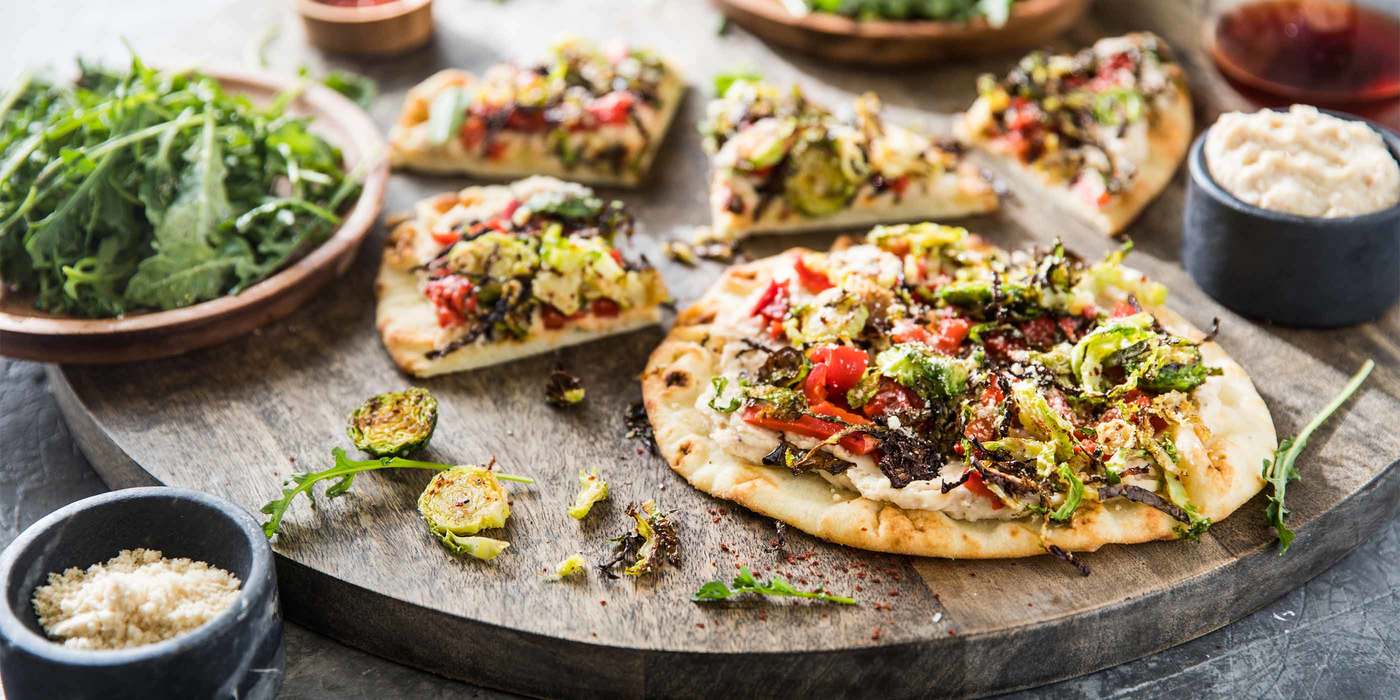 White Bean Hummus Flatbread with Crispy Brussels & Roasted Red Peppers