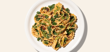 One-Pot Mafaldine tomato cream sauce, kale, parsley-hemp topping