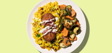 Vibrant Falafel Bowl pickled veggies, turmeric orzo, tzatziki