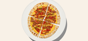 Cheesesteak Seitan Pizzas creamy plant-based cheddar sauce, sautéed vegetables