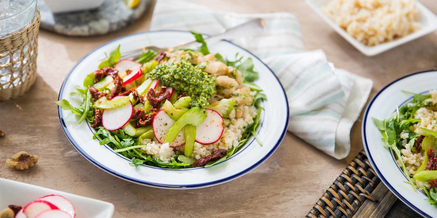 Tuscan Grain Bowl with Arugula Walnut Pesto and Sun Dried Tomatoes