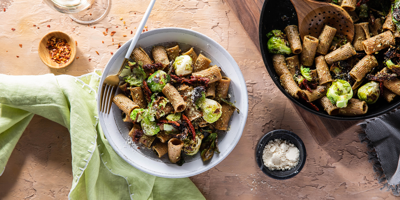 Pesto al Rigatoni with Crispy Brussels Sprouts & Sun-Dried Tomatoes